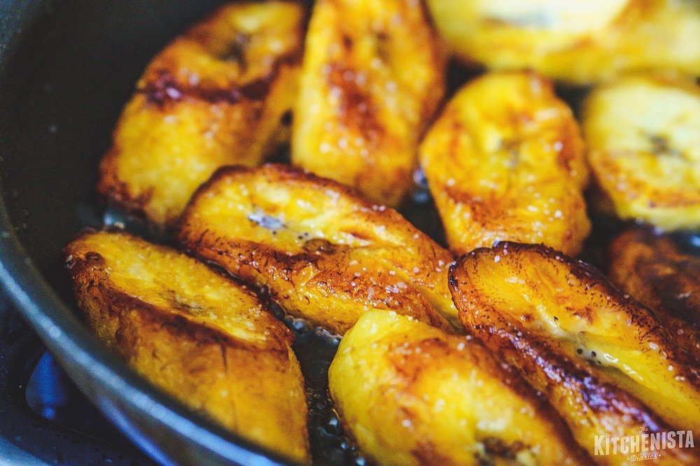 Sweet plantain frying golden in the pan at Bready's Delights